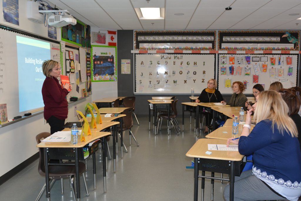 A group of parents turn their attention to the presenter who is sharing her knowledge on resilience. 