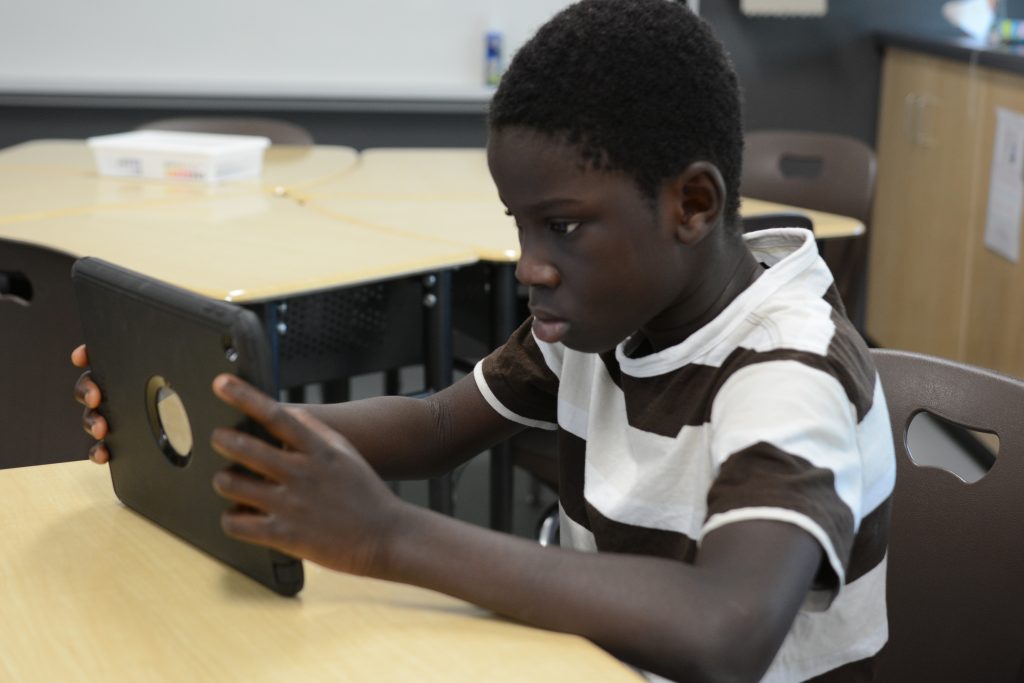 A student completes a reading level on Lexia on his iPad