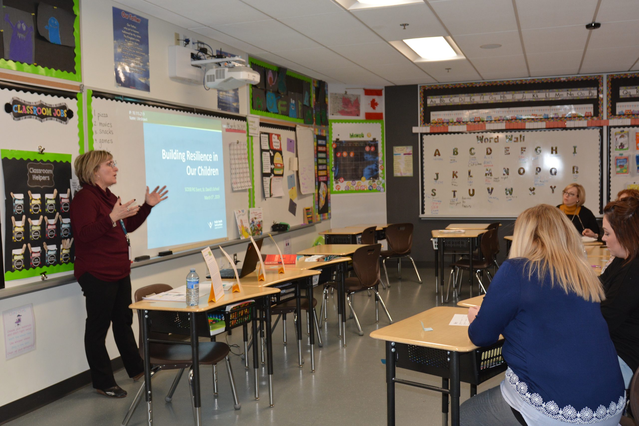 A women talks to a classroom full of parents.