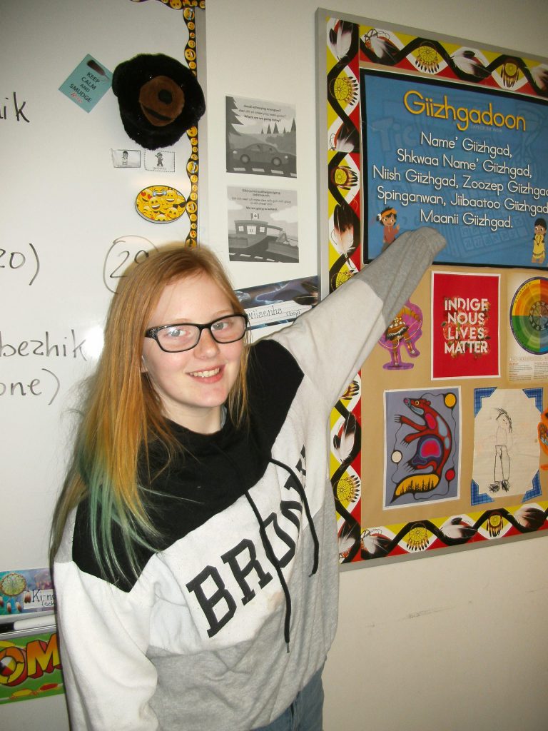 Girl points to a bulletin board