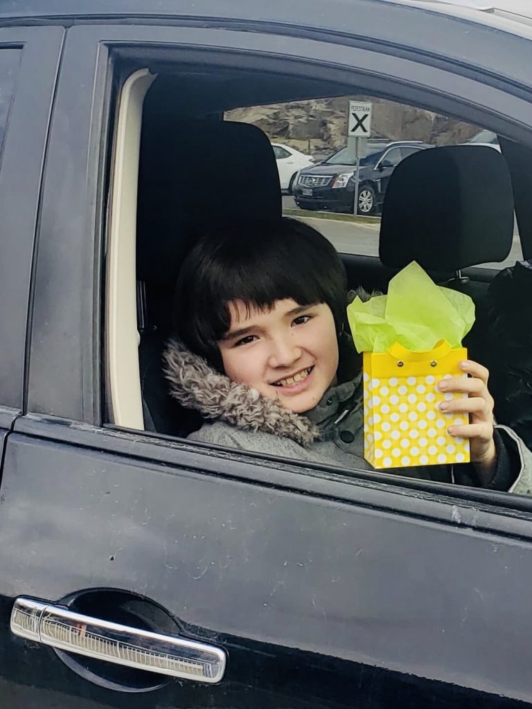 Boy holds up his gift