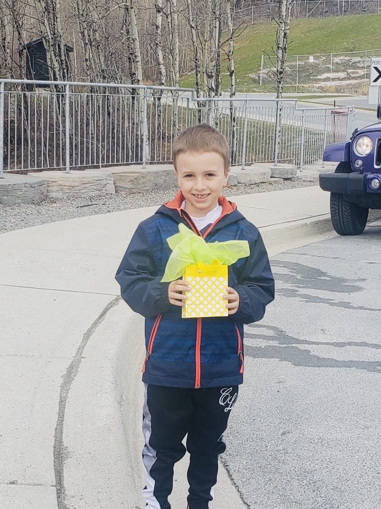 Boy holds up his gift