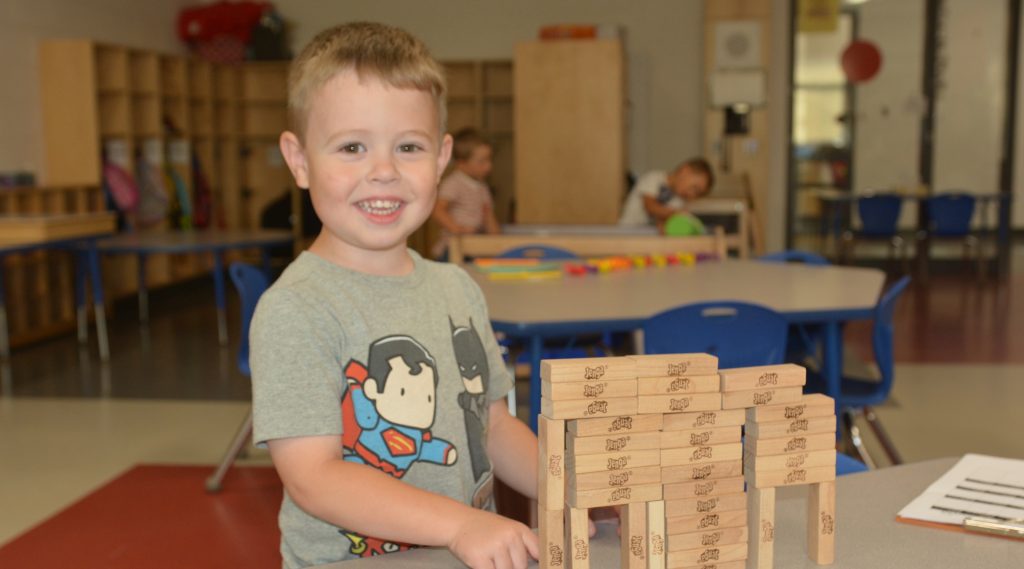 A boy plays with blocks during the school readiness program at Holy Trintiy School.