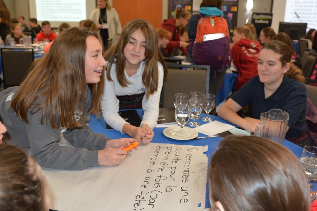 Students from Marymount Acdemy work together to complete a French question.