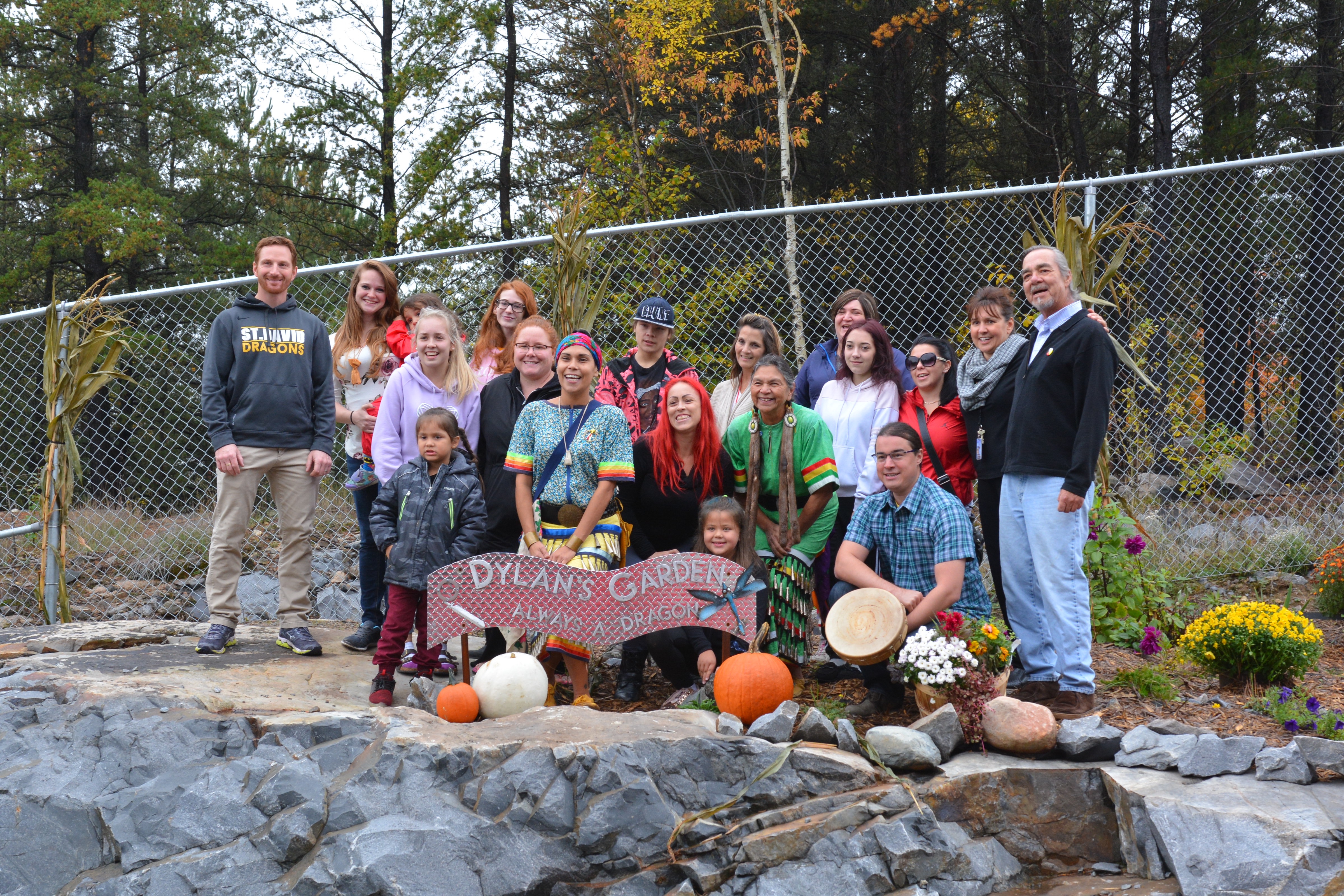 Family and friends of Dylan Fay stand in the brand new memorial garden with plantss, flowers and a special plaque.