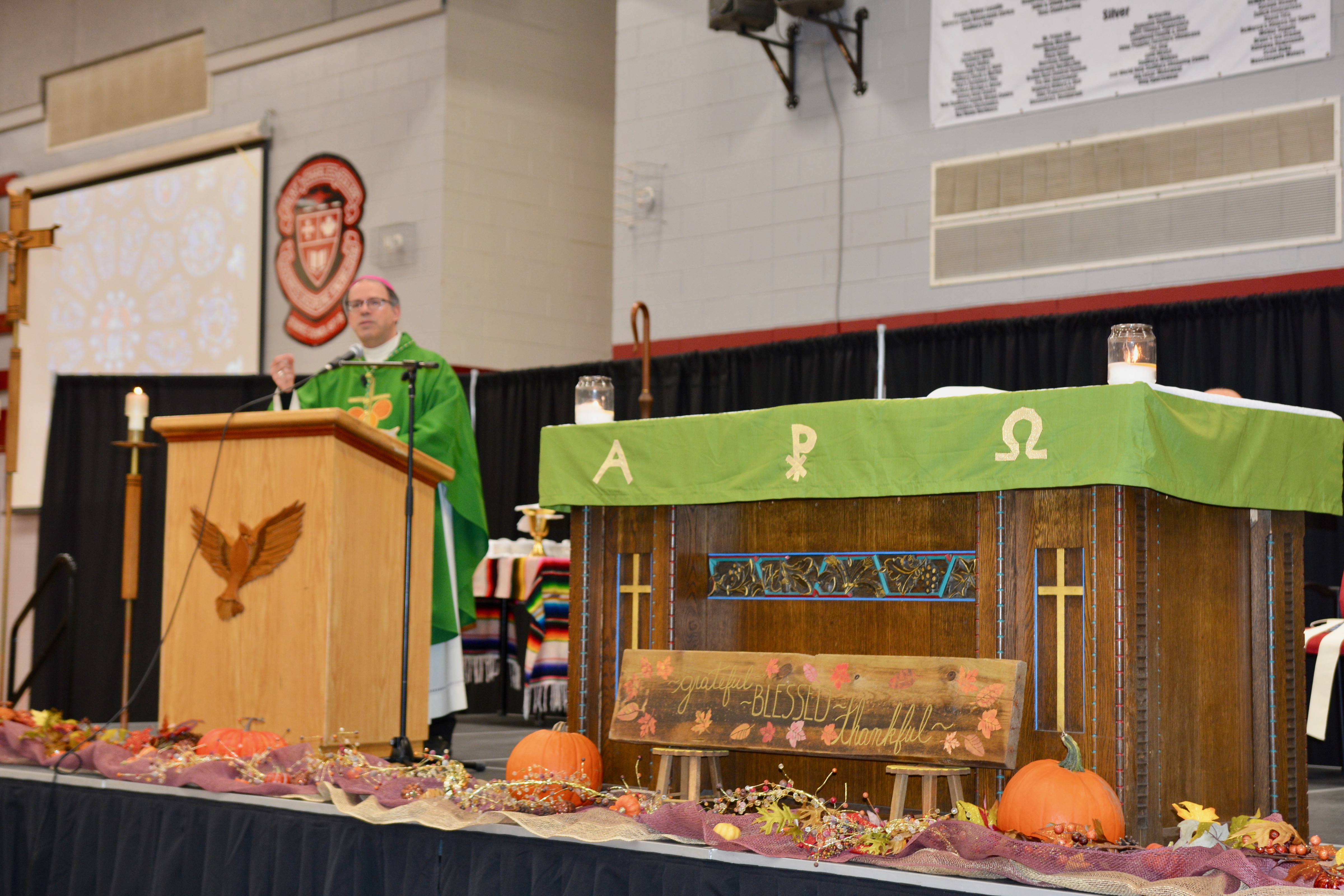 Bishop Marcel Damphousse performs the Mass on stage in front of all Sudbruy Catholic staff.