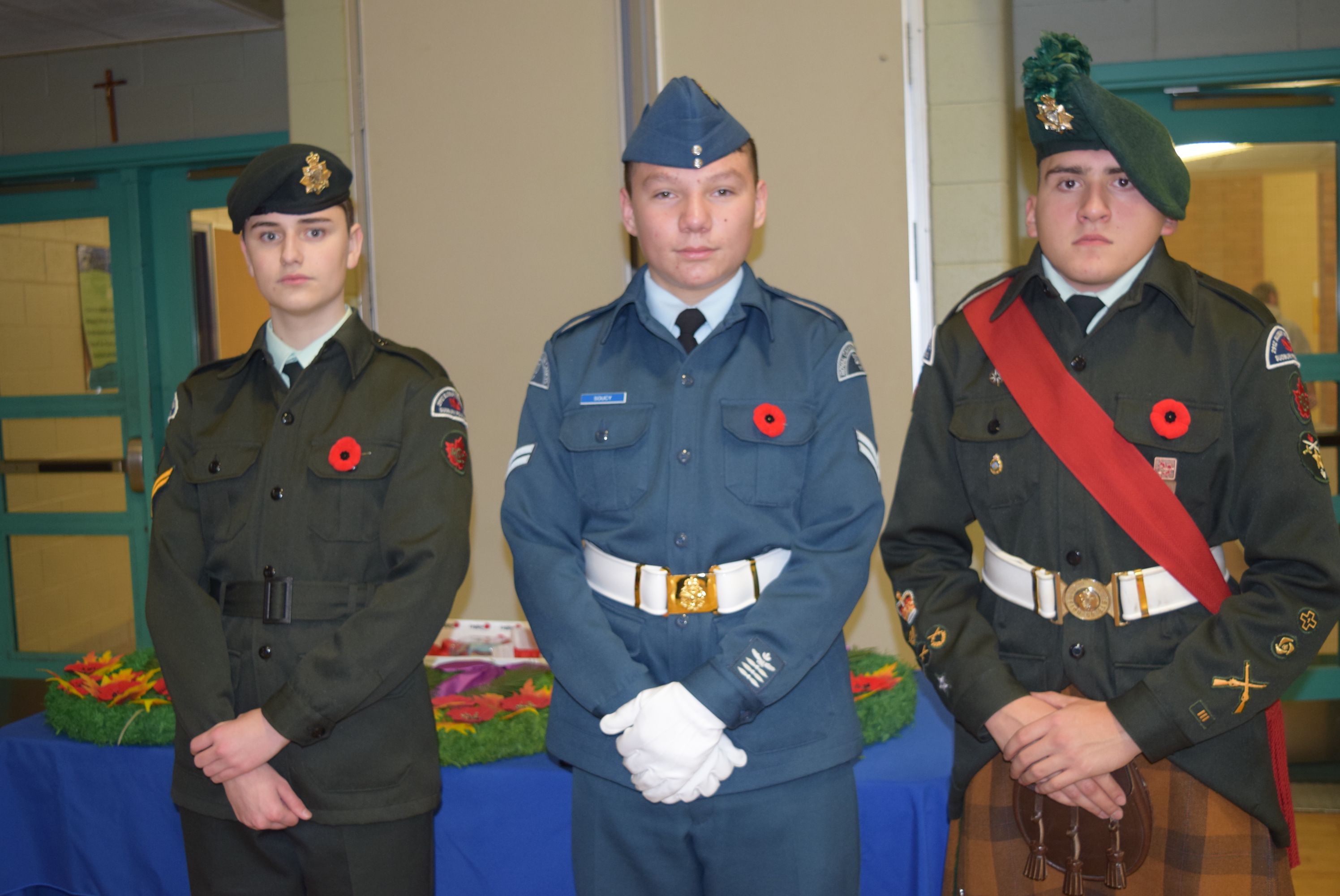 Cadet representatives stand alongside the Remembrance Day wreathes.