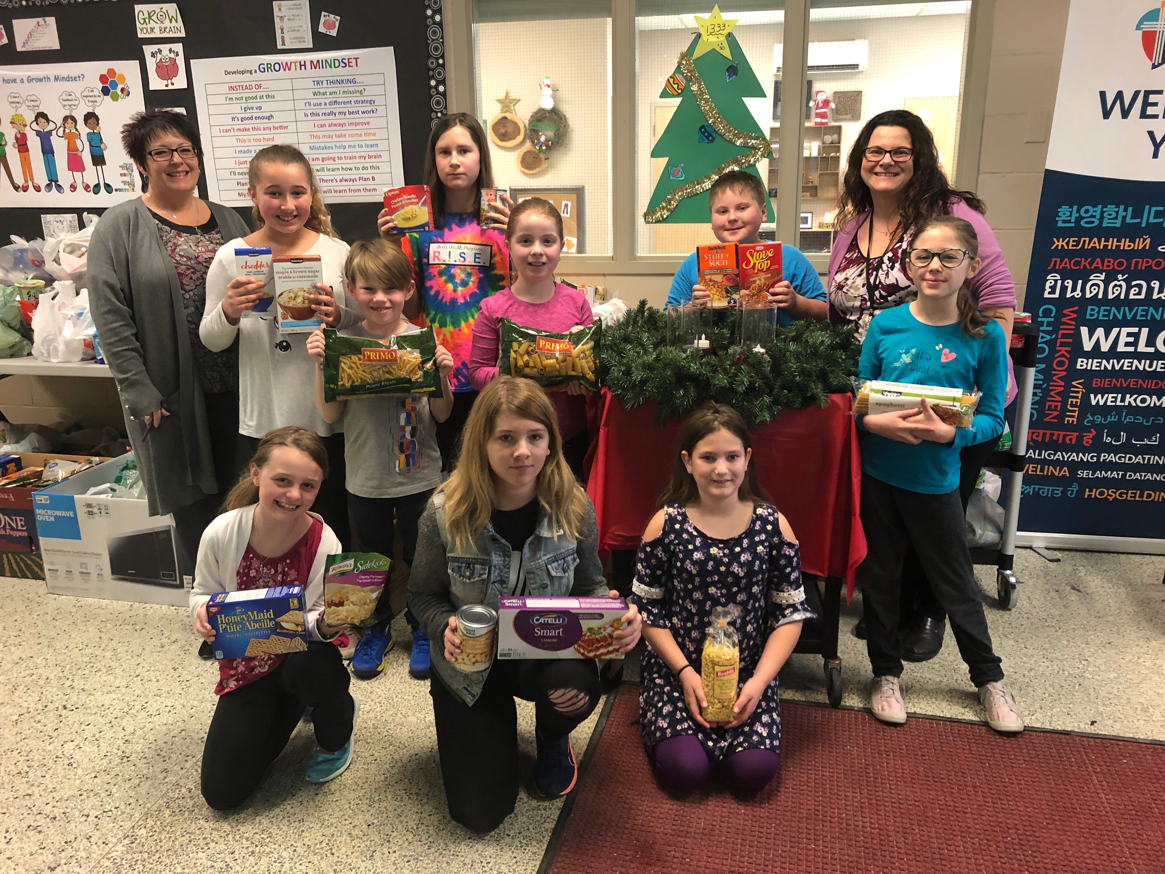 Students gather together with their canned food donations