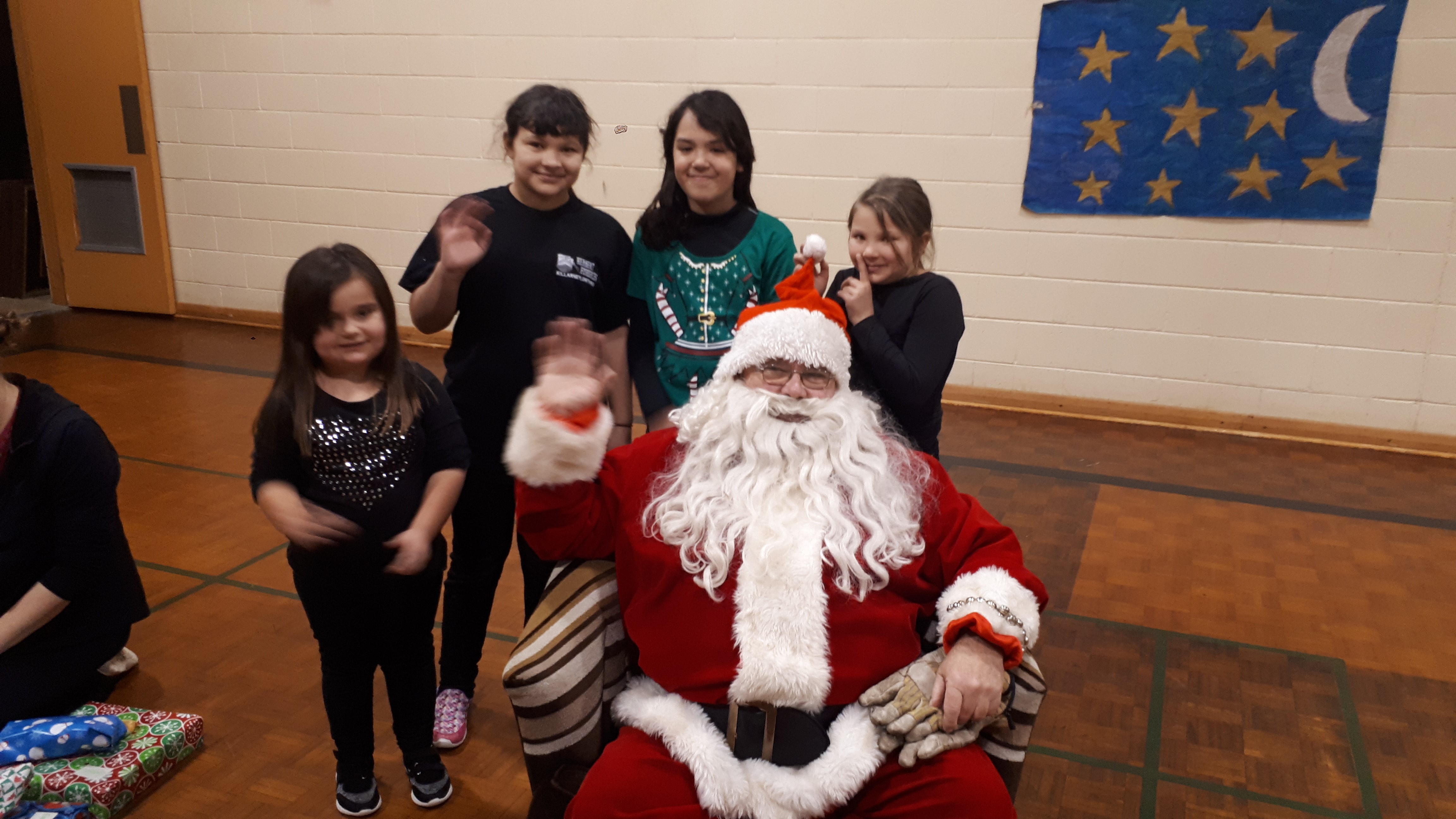 Students Jessica Pawson, Abby Beaucage, Channel Burant-Roque and Emily Beaucage pose with Santa