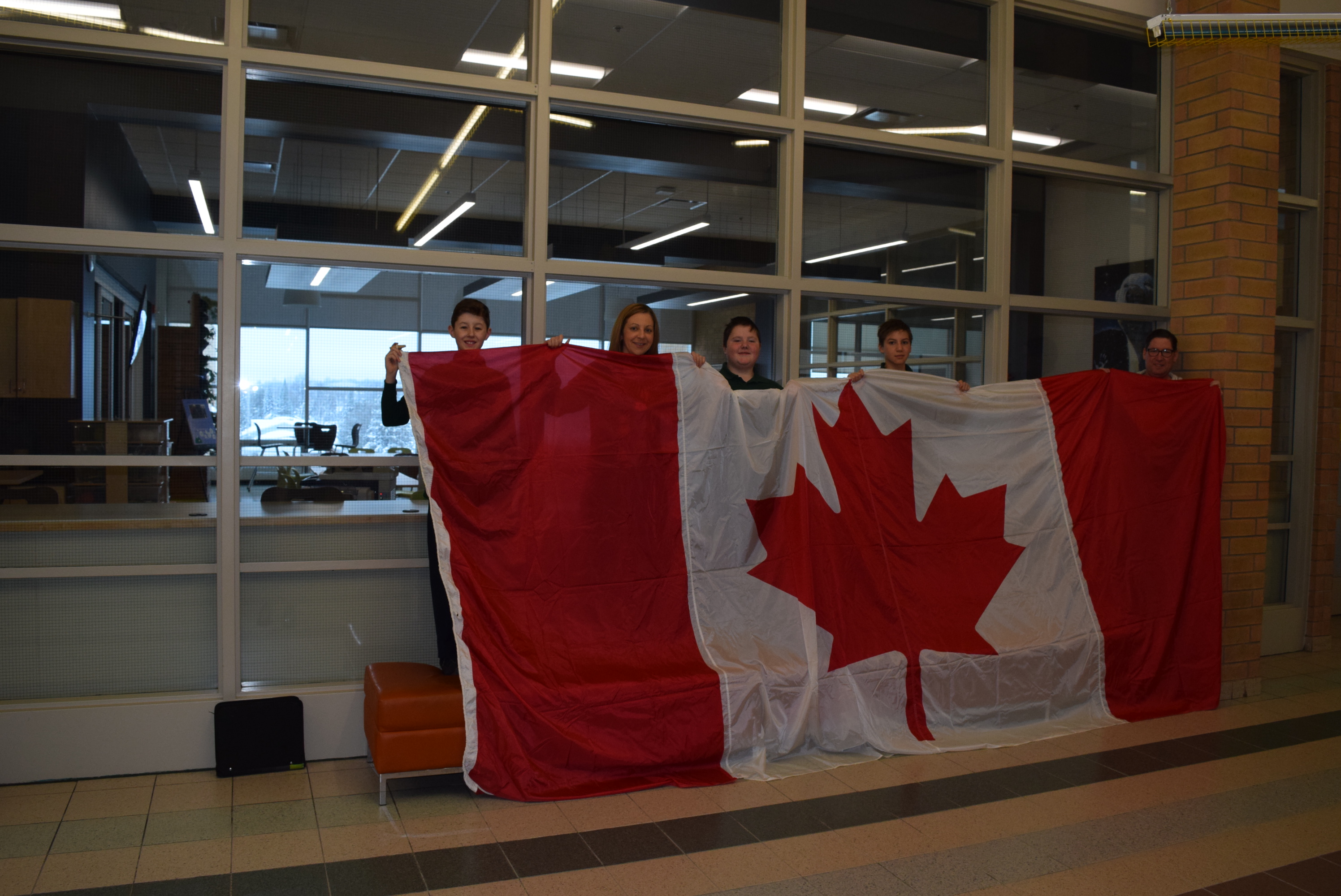 St. Benedict students hold up the Canadian flag with pride.