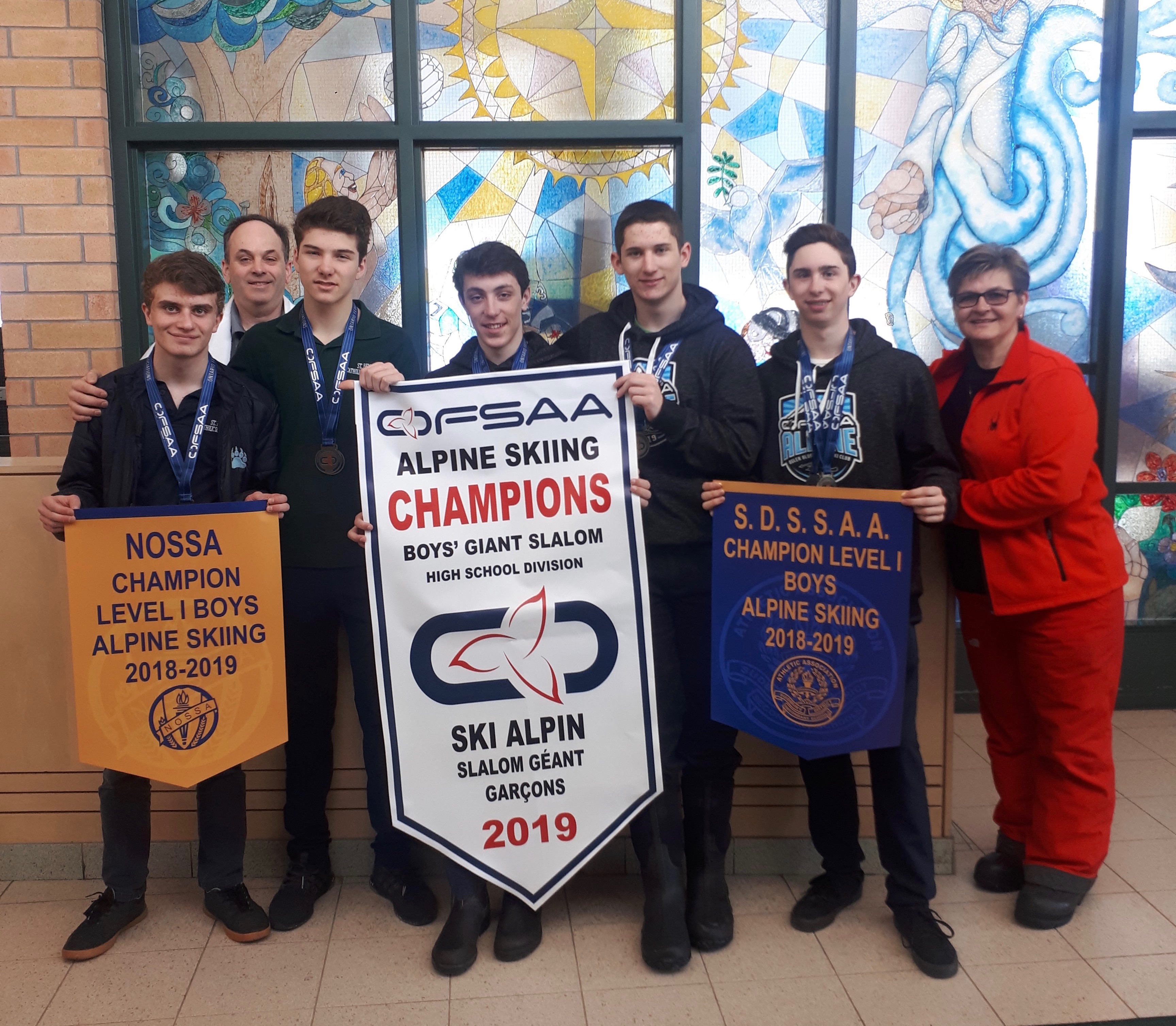 The Alpine Ski team at ST. Benedict stands with their OFSAA Banners.