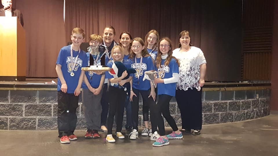 St John Students stand with their trophy.