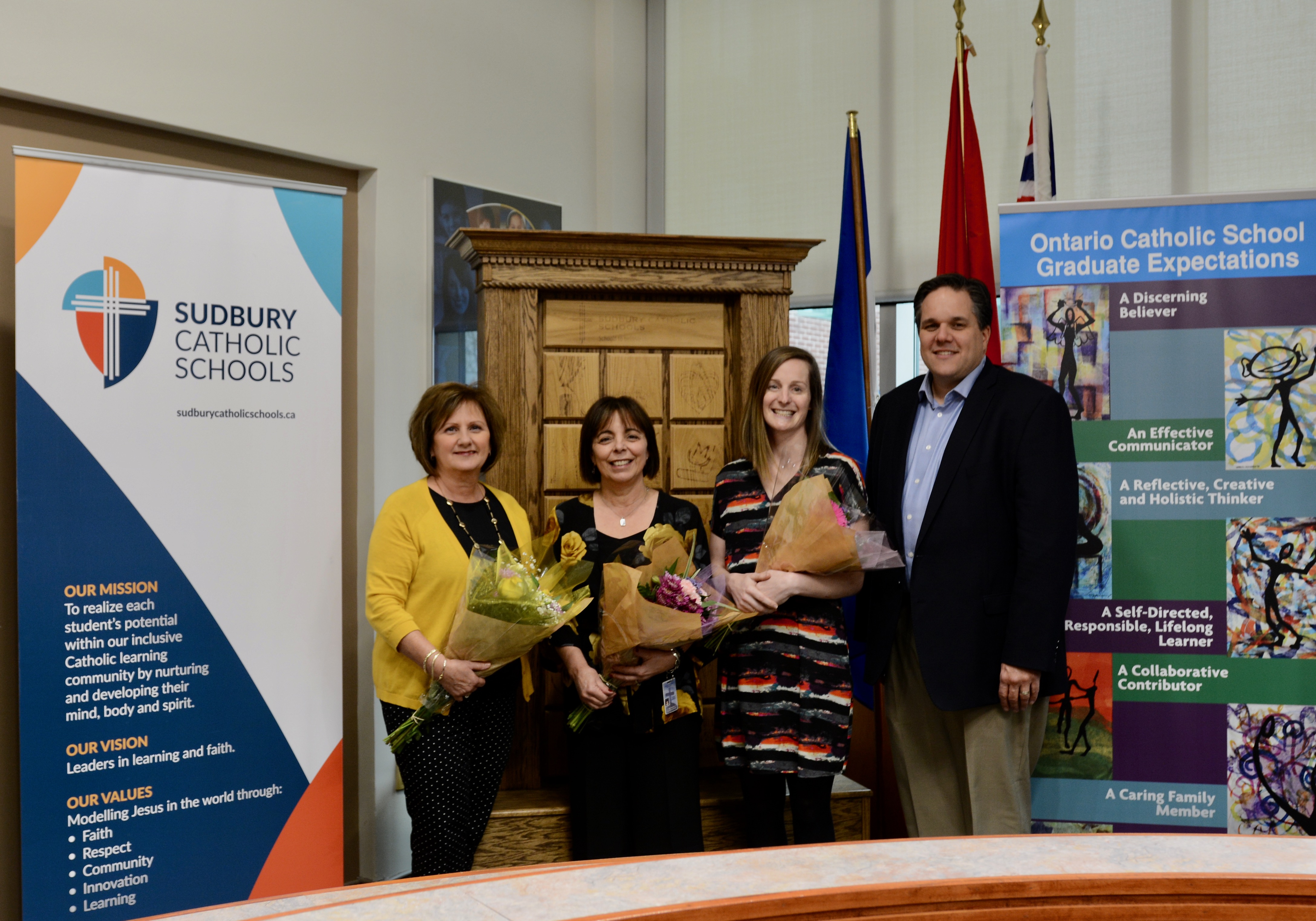 Award Winners, Joanne, Maria and Julie stand with Chairperson Michael Bellmore.