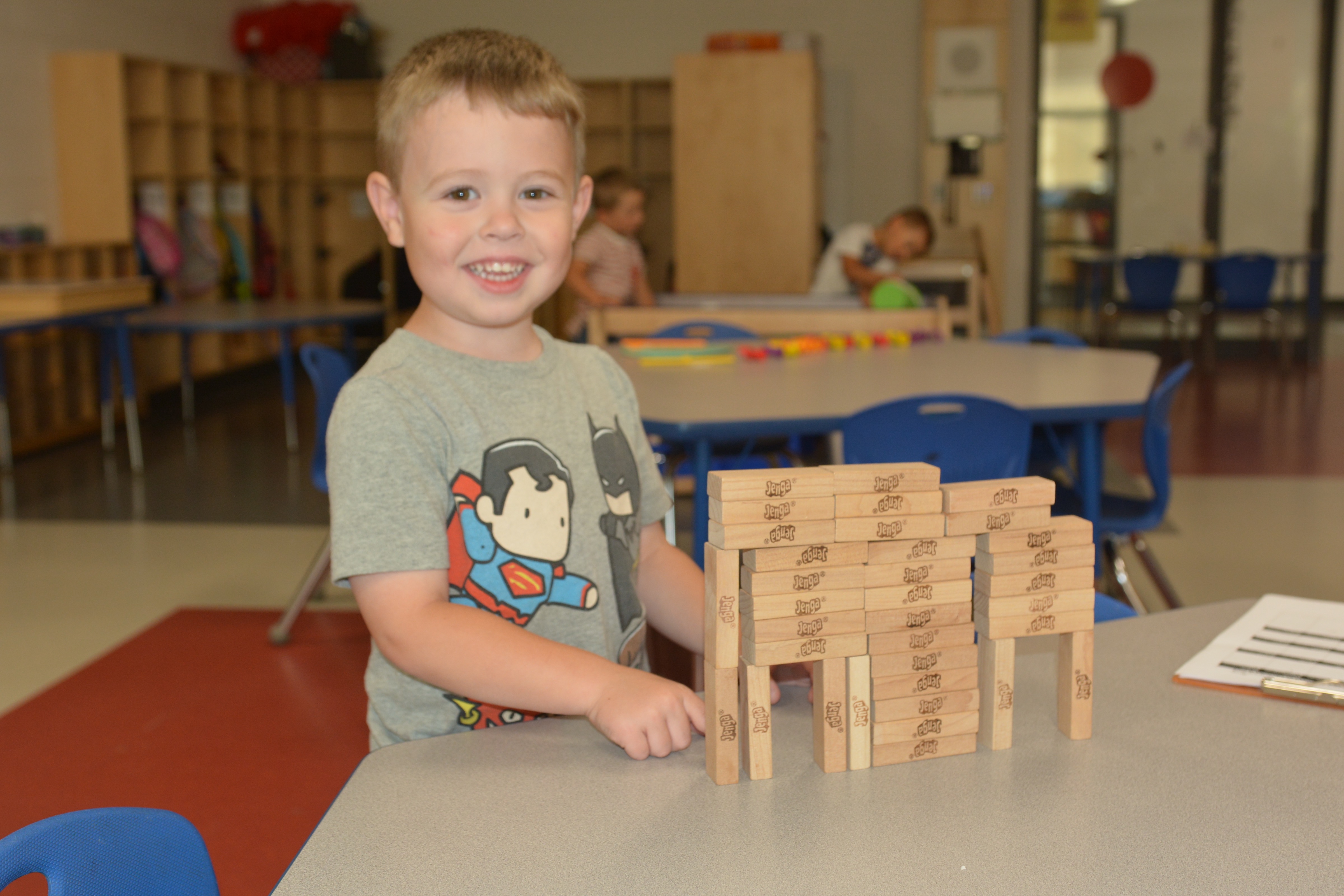A boy stands with his blocks
