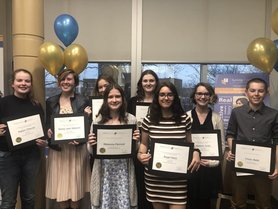 Essay Winners stand with their certificates.