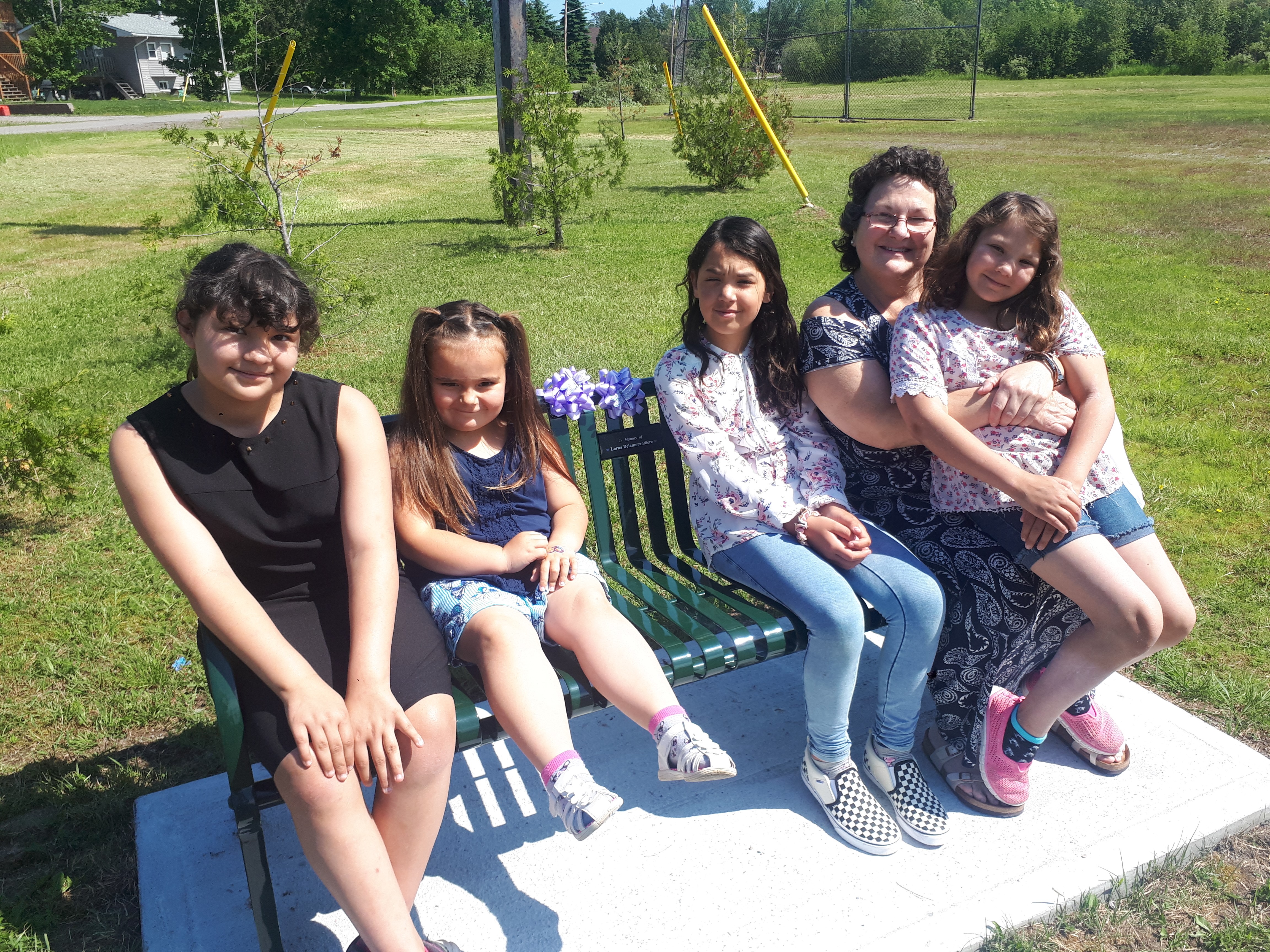 Students sit on the memorial bench.