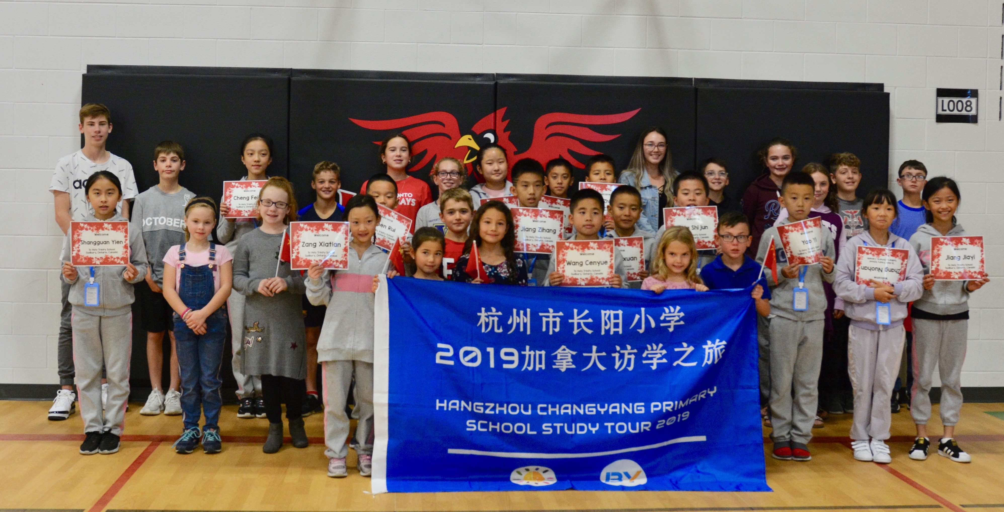 Visiting Chinese Students stand with their billet students from Holy Trinity School