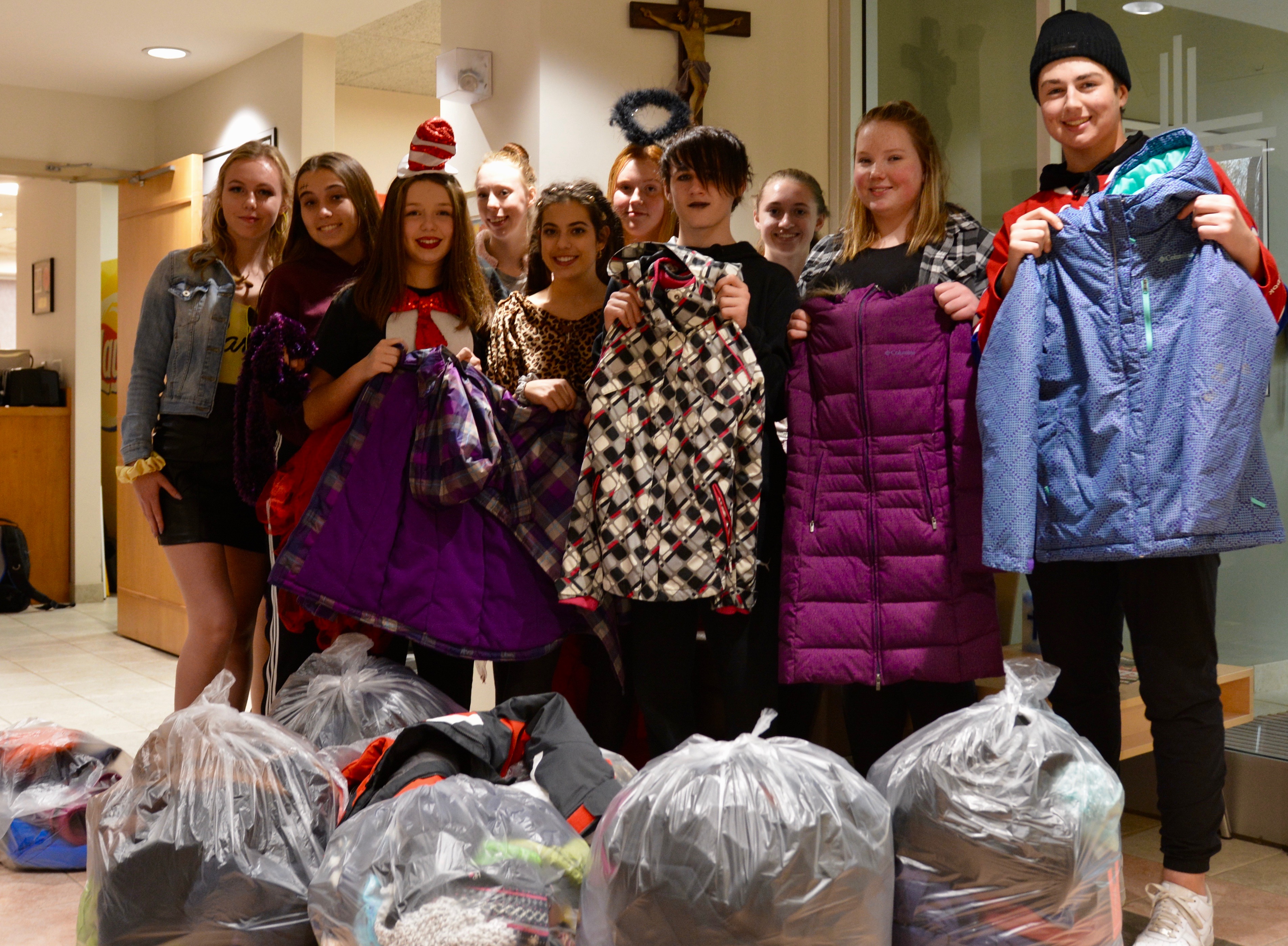 Members of student senate stand with their coats.