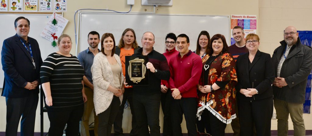 Teachers pose with EQAO Award