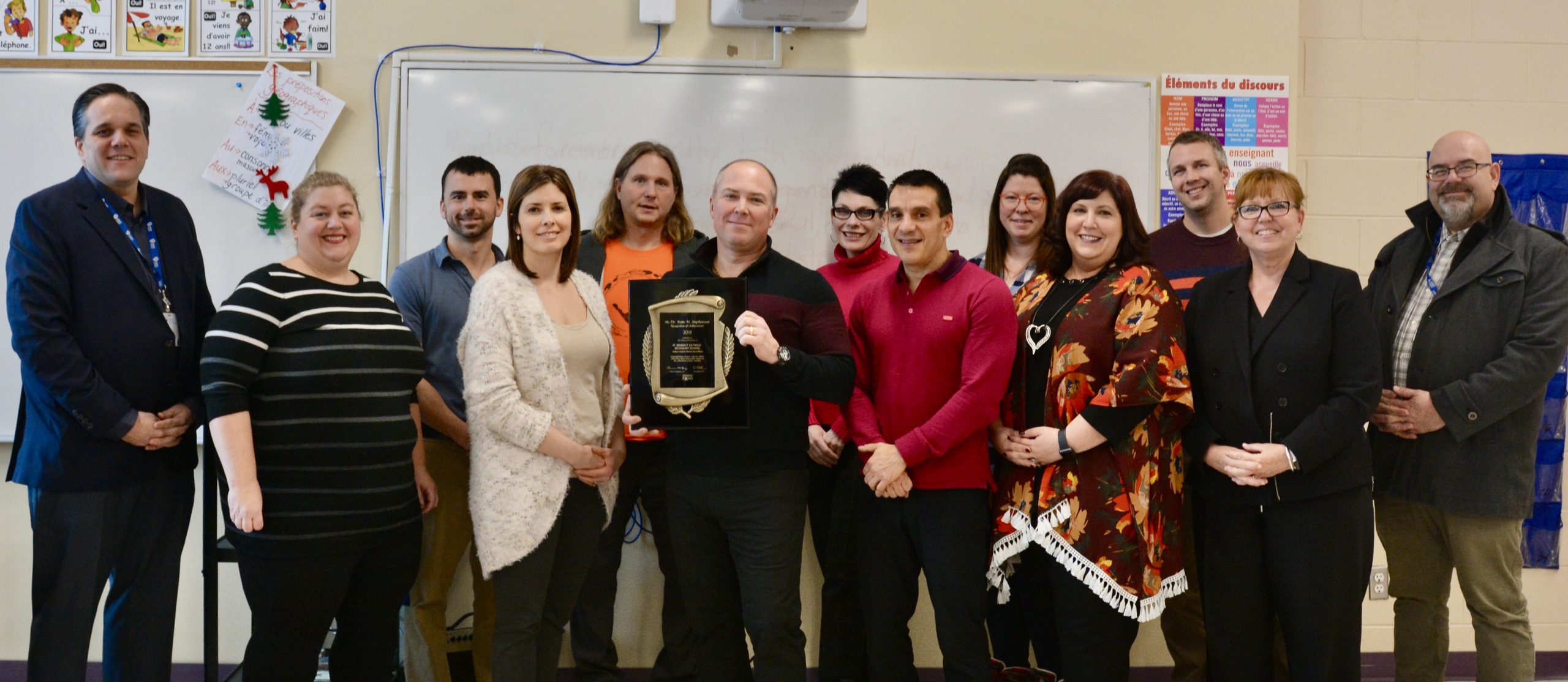 Teachers pose with EQAO Award