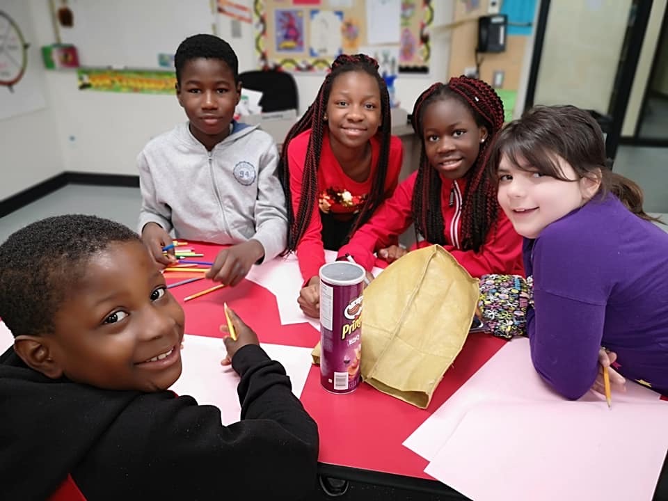 Group of students write on paper.