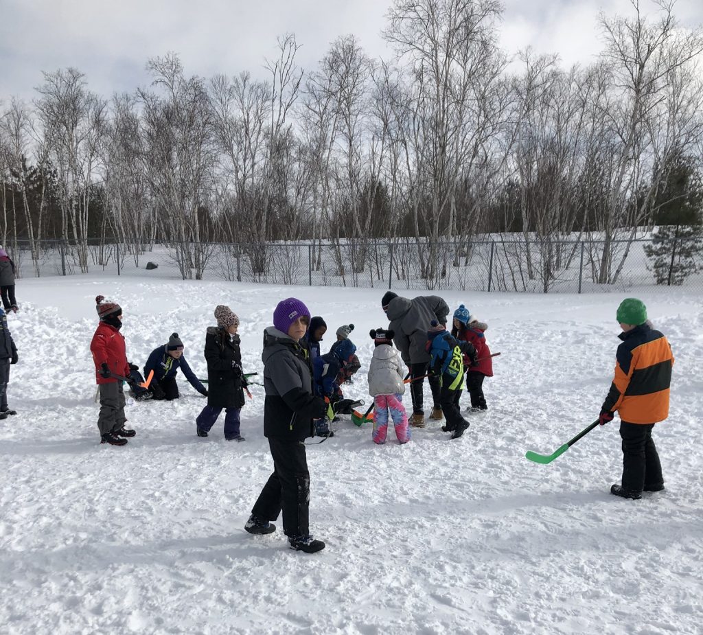 Kids playing outside in the snow