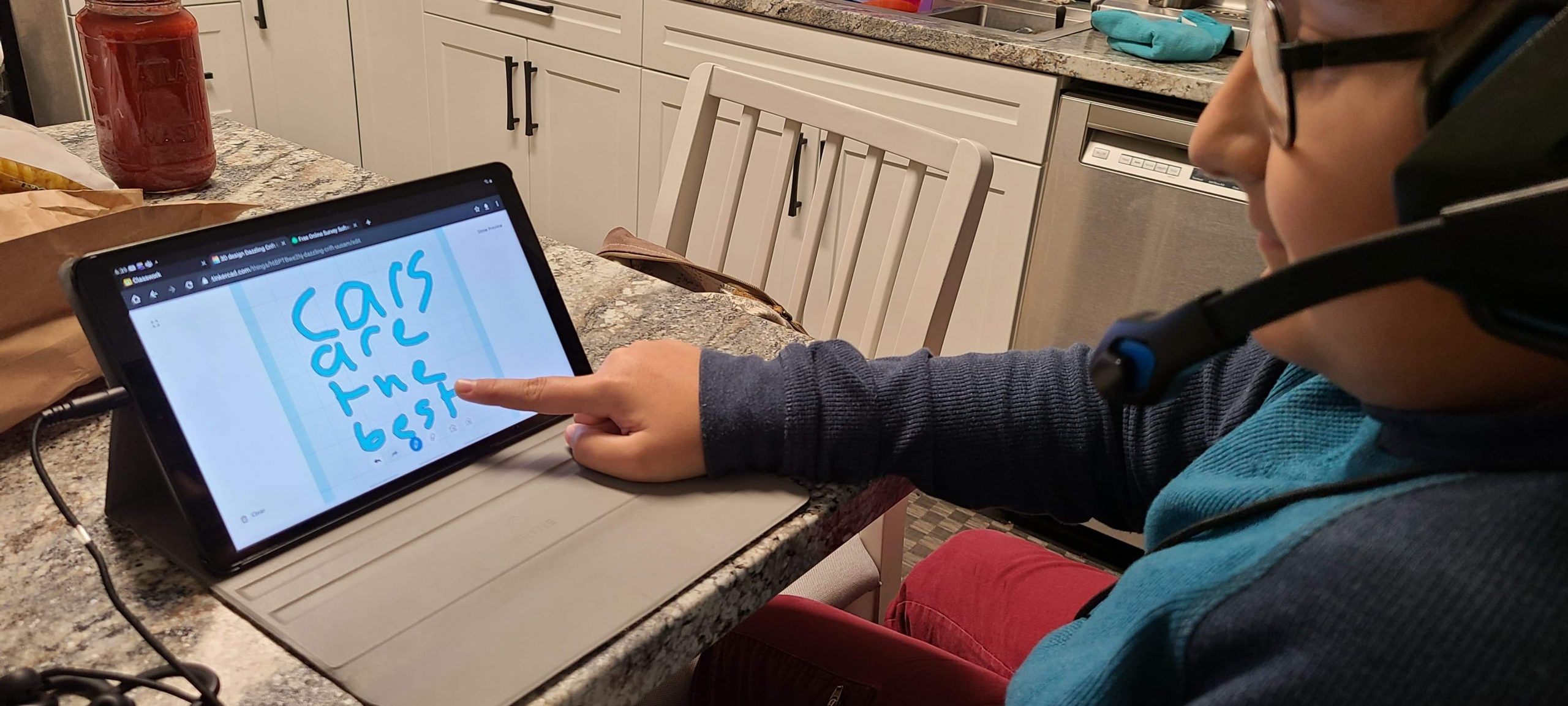 A boy works on his iPad