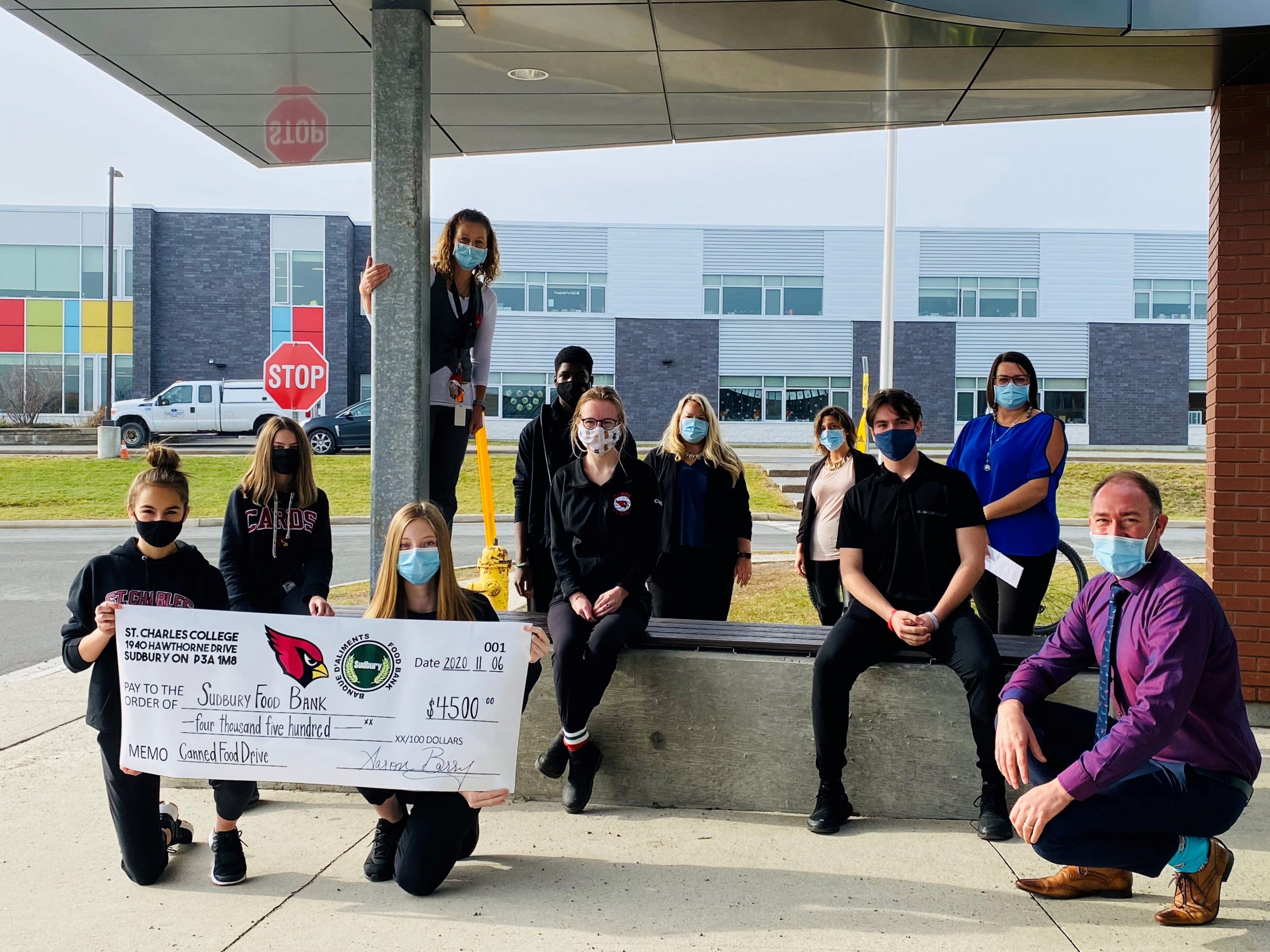 Students and staff present a cheque