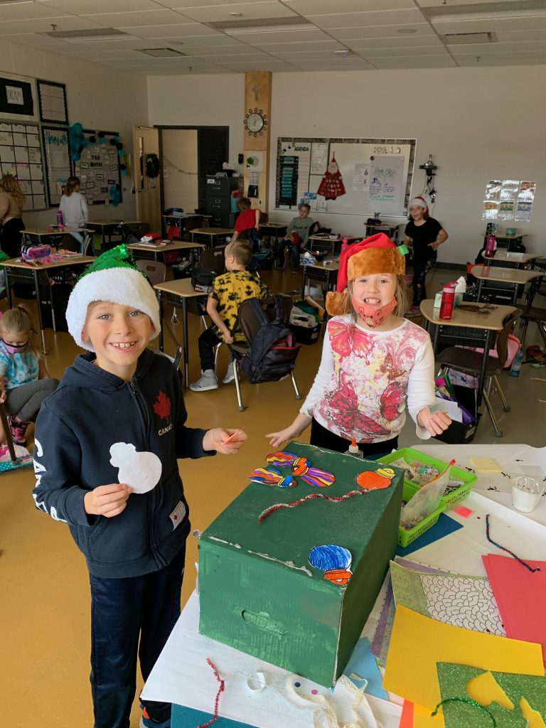 Two students and a cardboard box