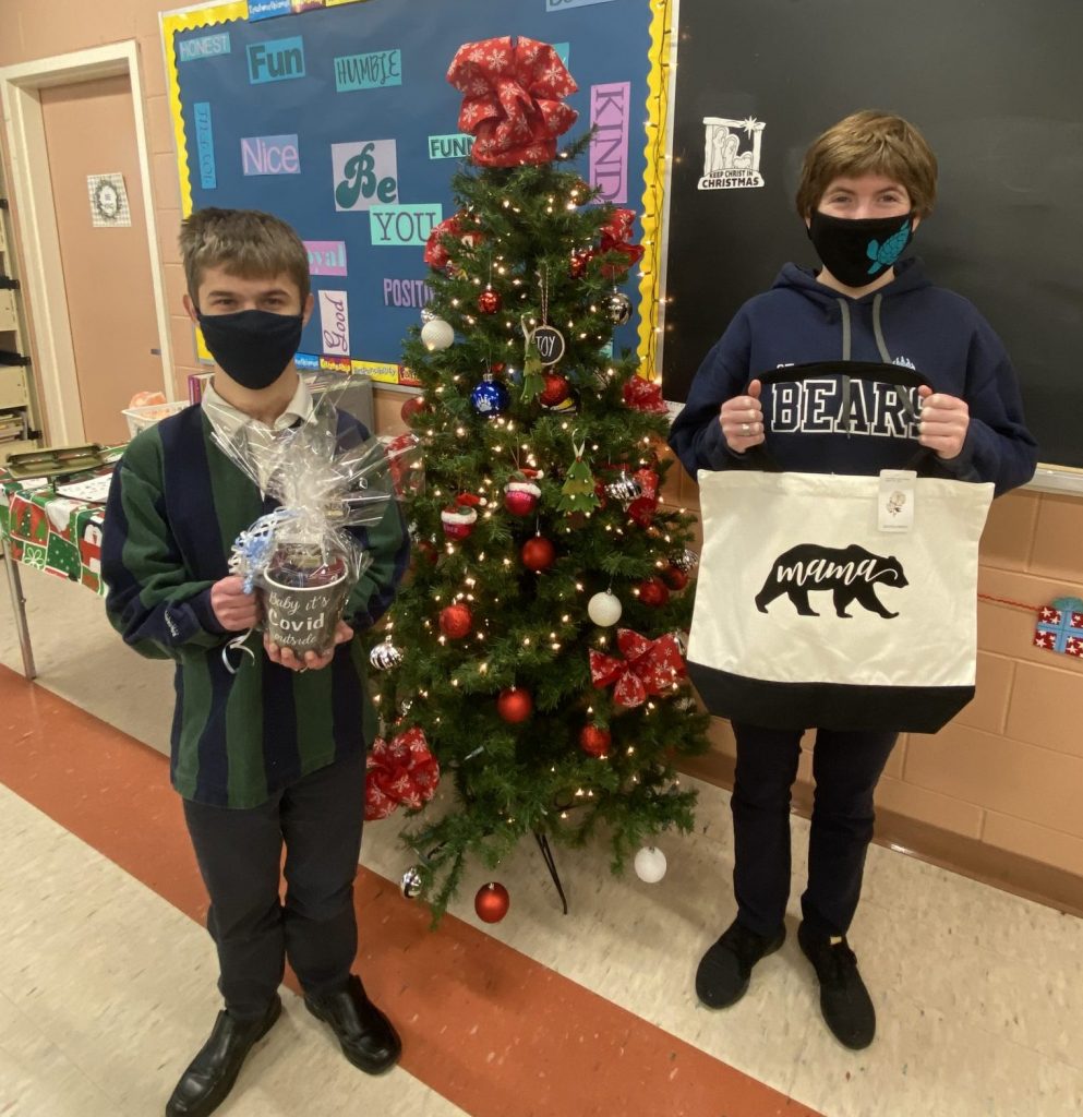 Two students stand near tree