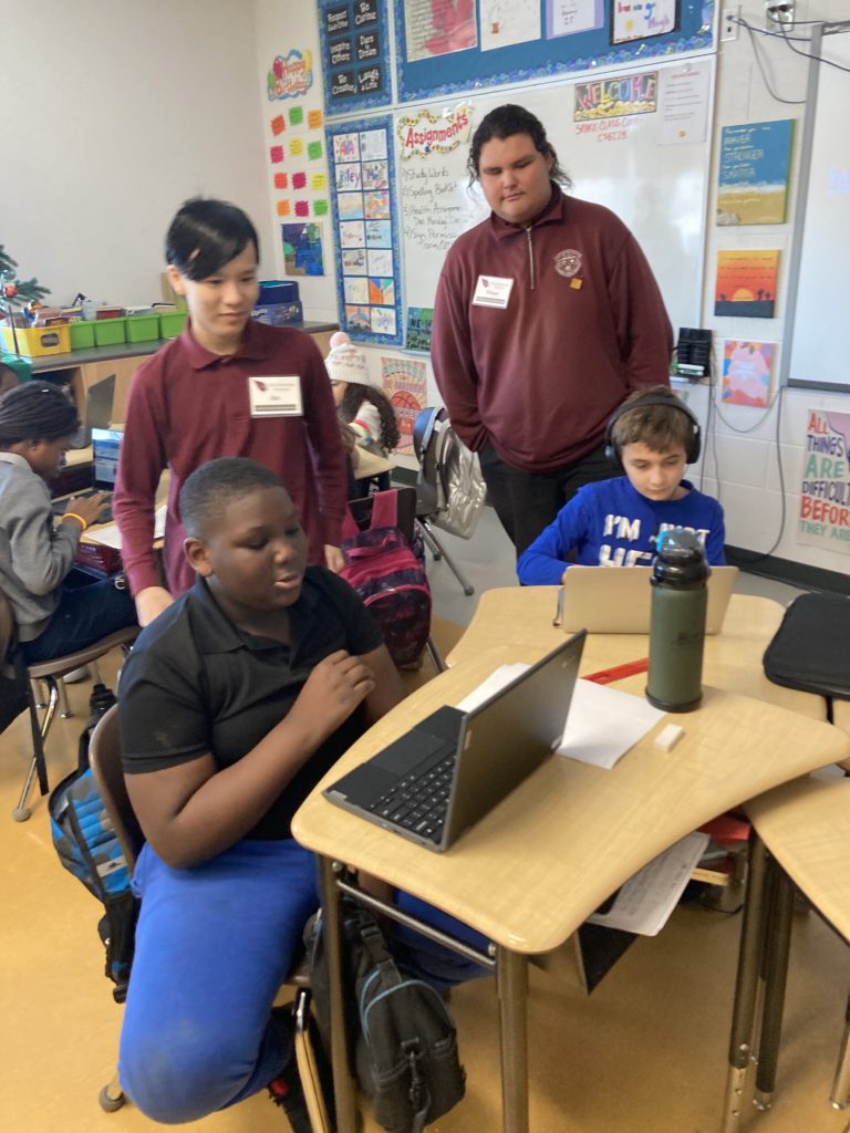 Students work together on laptops