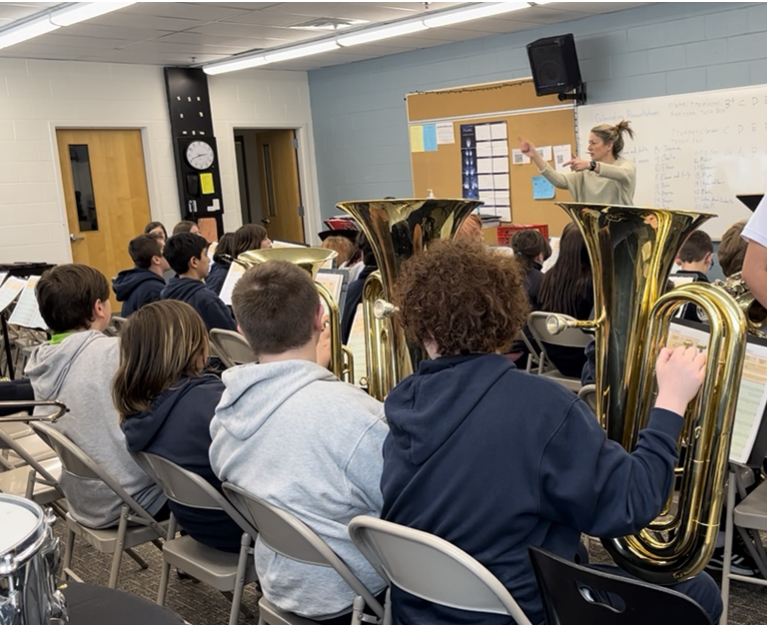 Principal leads students in band